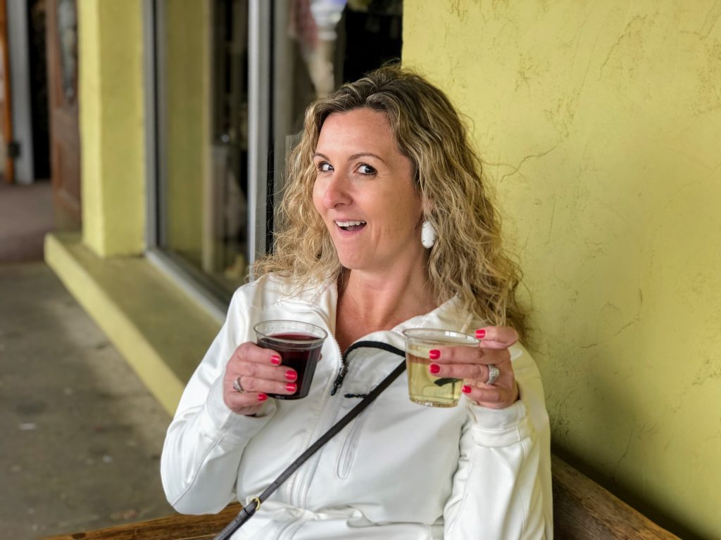 girl holding 2 glasses of wine