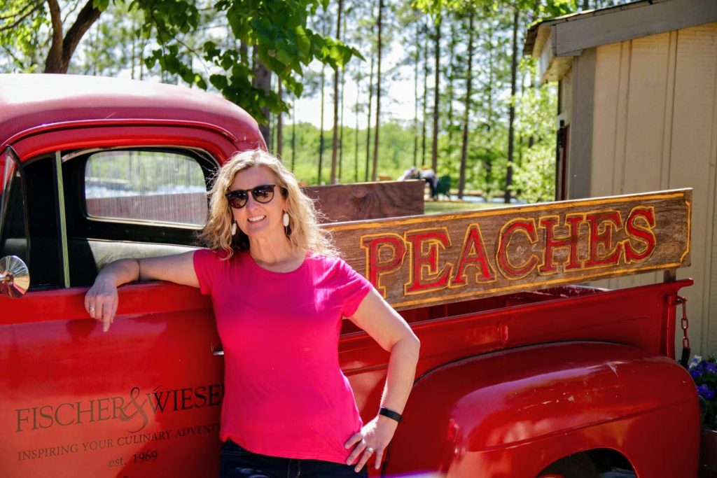 girl standing by a truck that says Peaches
