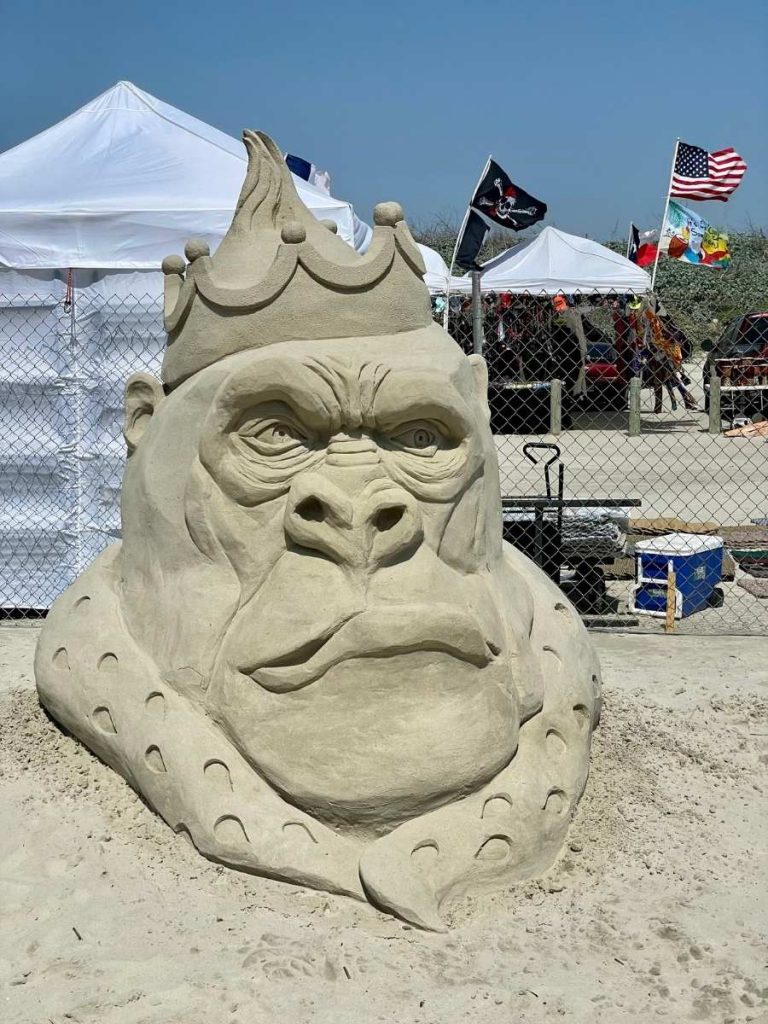ape wearing a crown made of sand